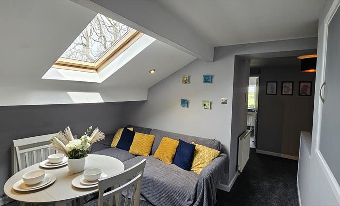 The Redford Cwtch Lounge – a cosy, welcoming space with soft seating, warm lighting, and rustic charm, perfect for relaxing with family or friends aft